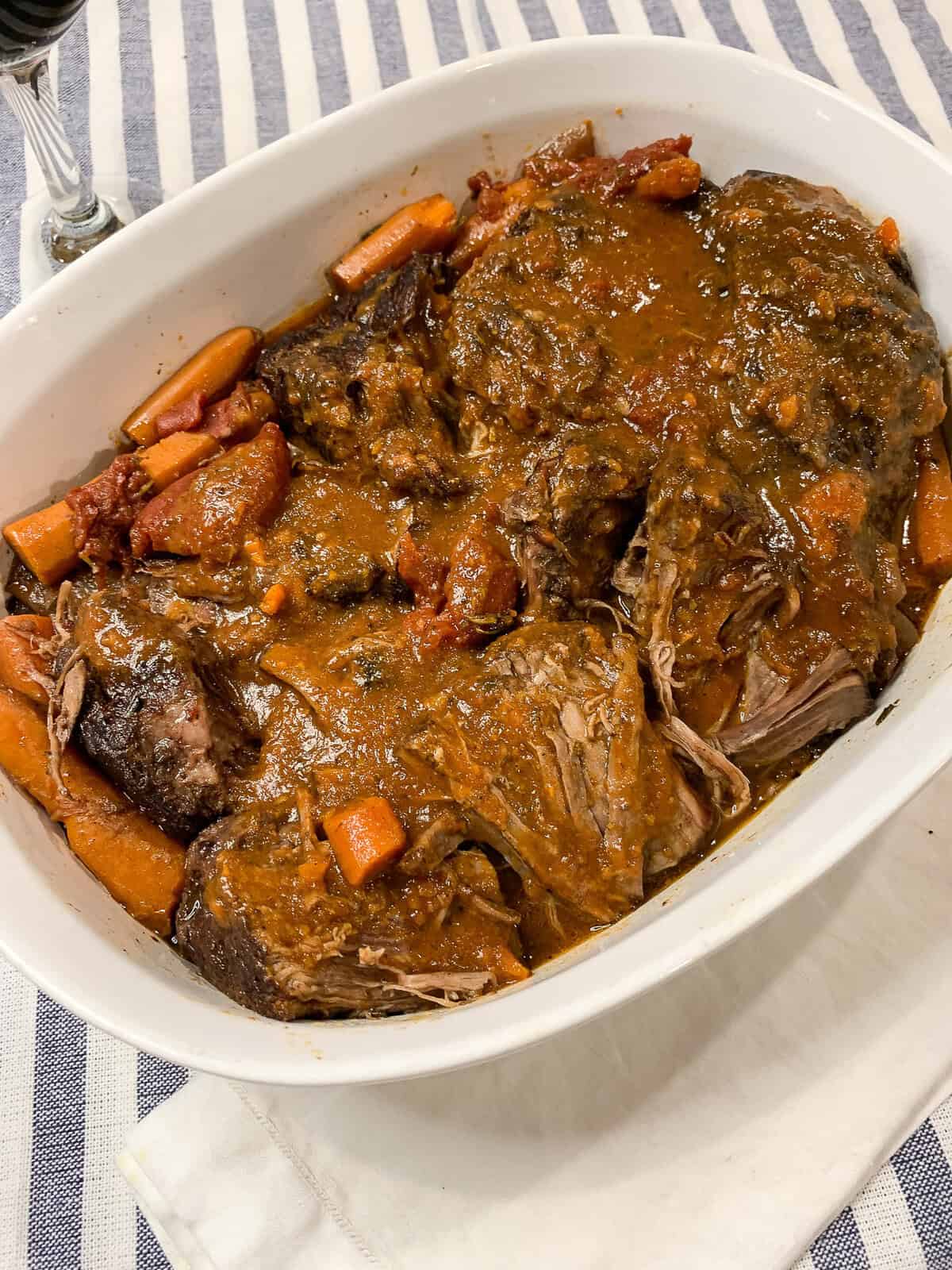 Brastato di manzo, known as stracotto or Italian pot roast) in a white casserole dish.