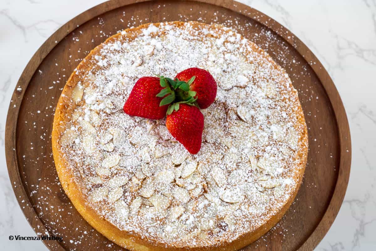 Italian almond cake dusted with powdered sugar and topped with strawberries.