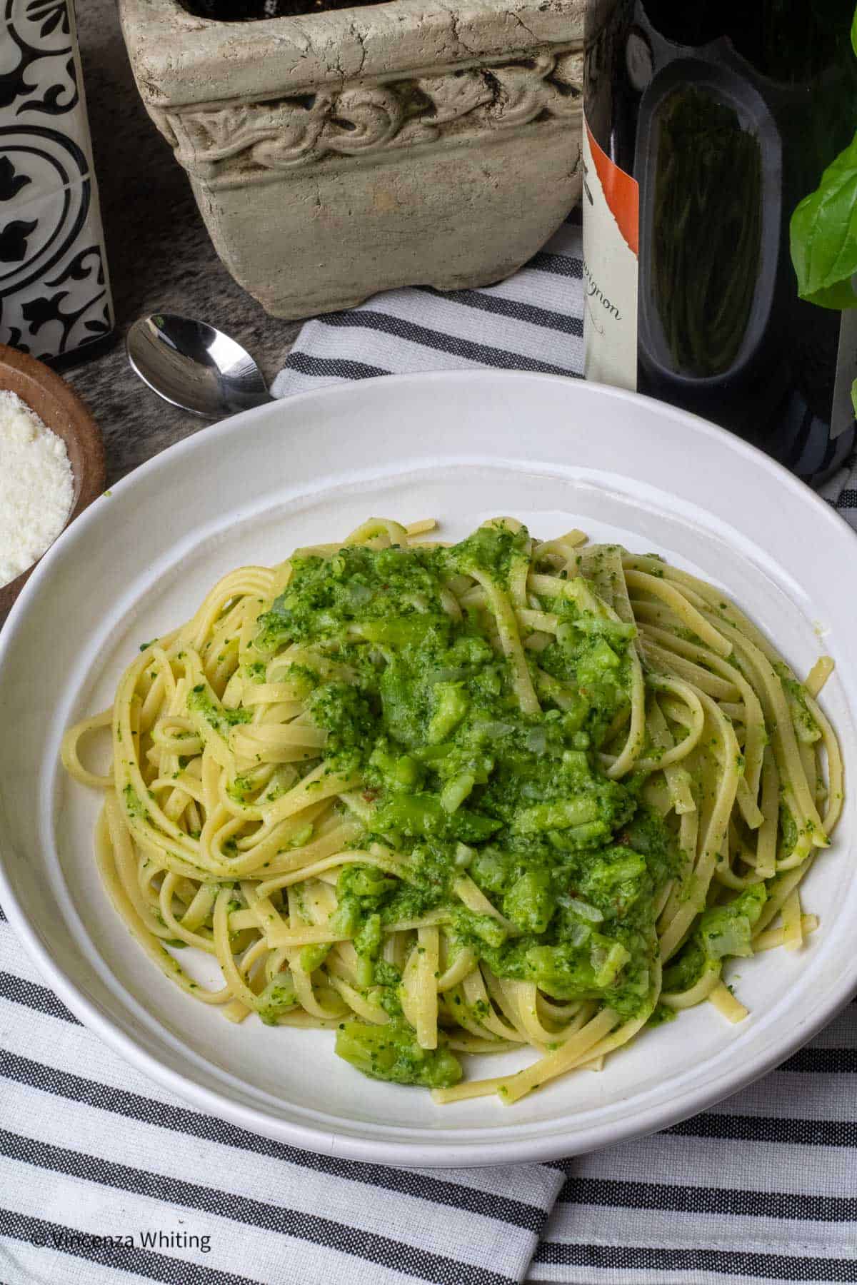 A bowl of pasta with broccoli sauce.