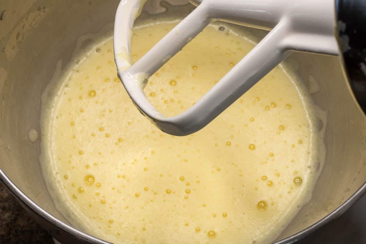 Frothy beaten eggs in a mixer bowl.