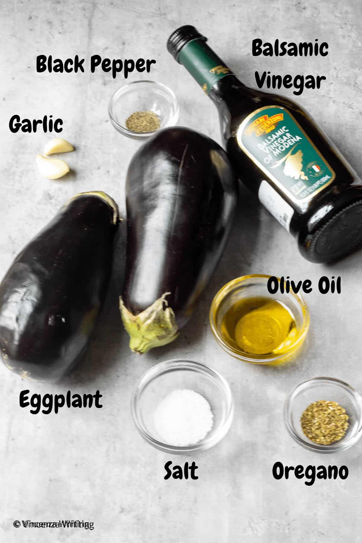 Ingredients to make grilled eggplant with balsamic vinegar, garlic, oregano and black pepper.