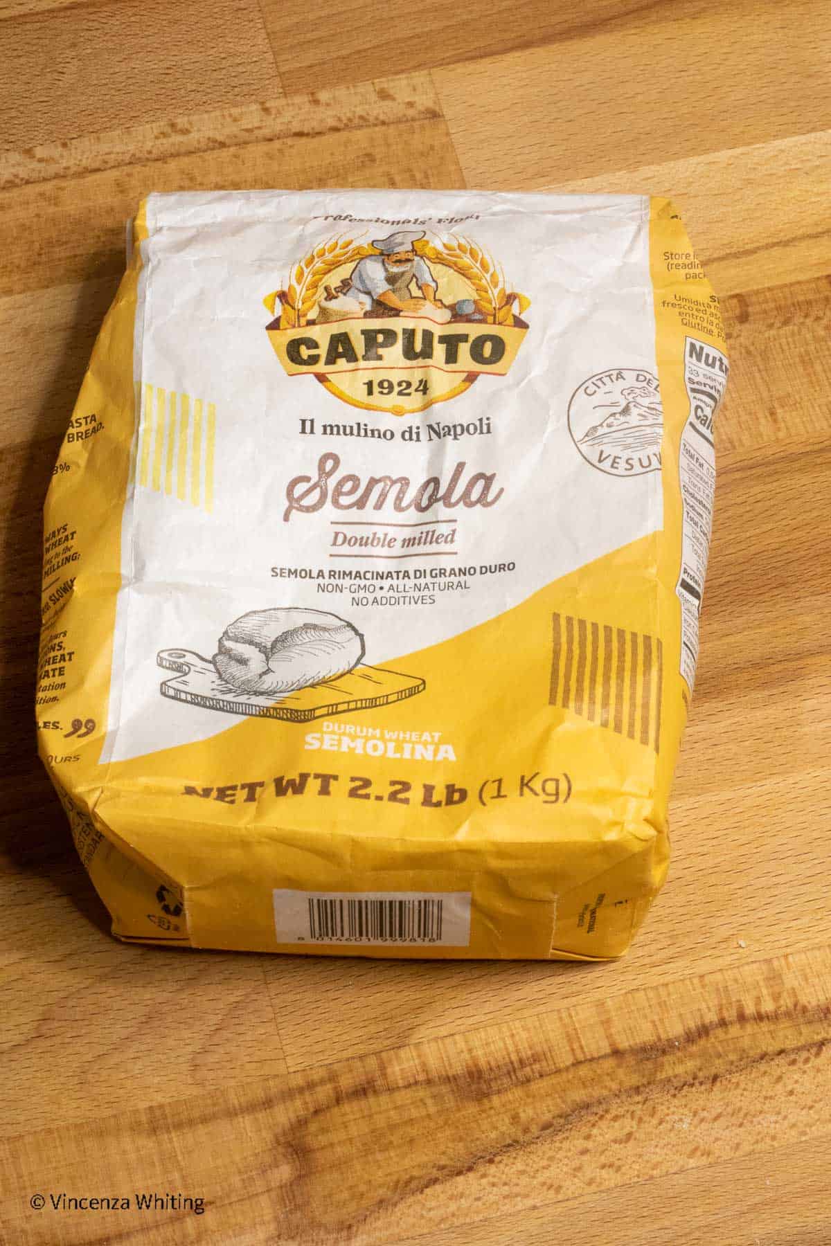 A bag of Caputo brand semolina flour on a wooden cutting board.