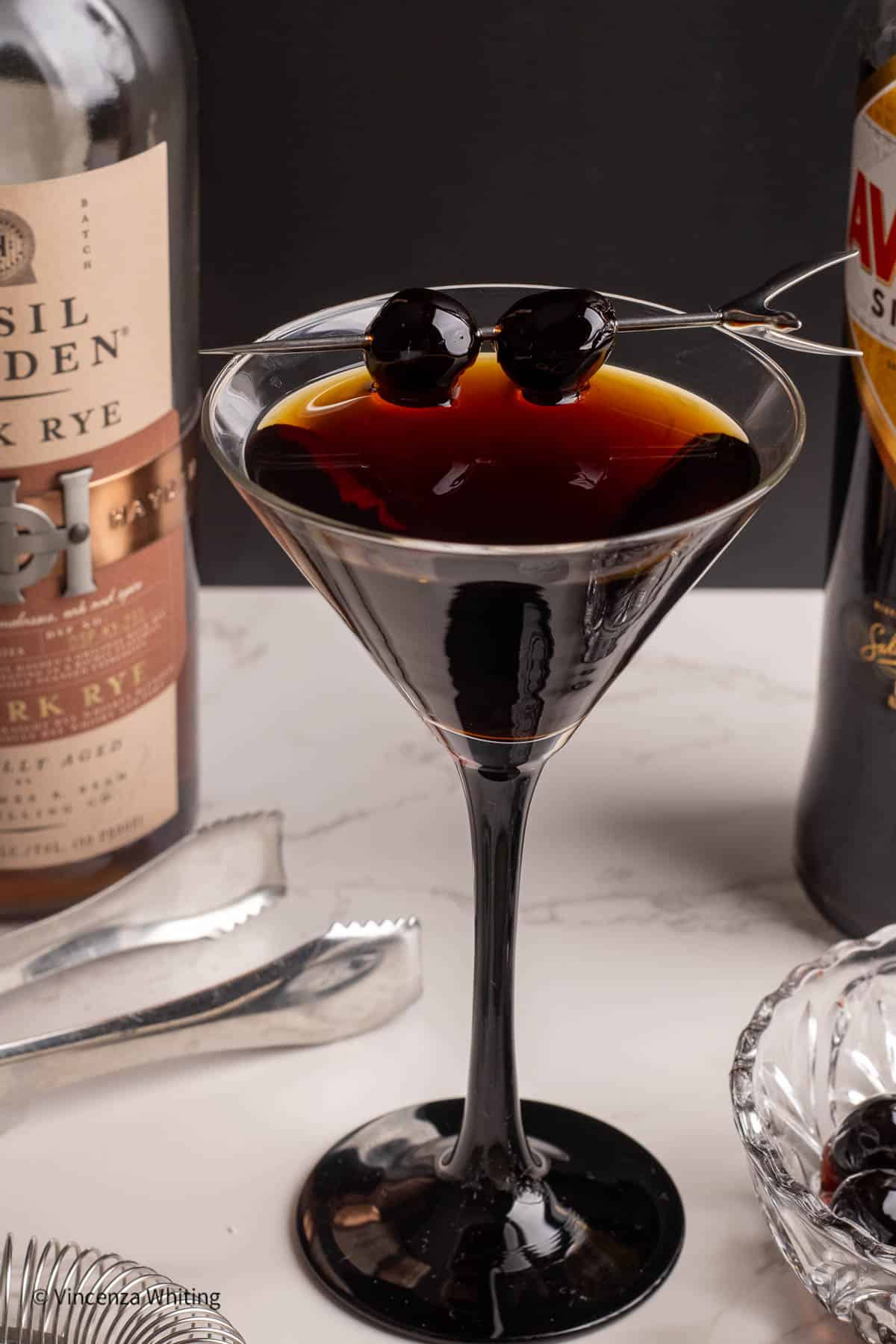 A Black Manhattan cocktail in a martini glass.