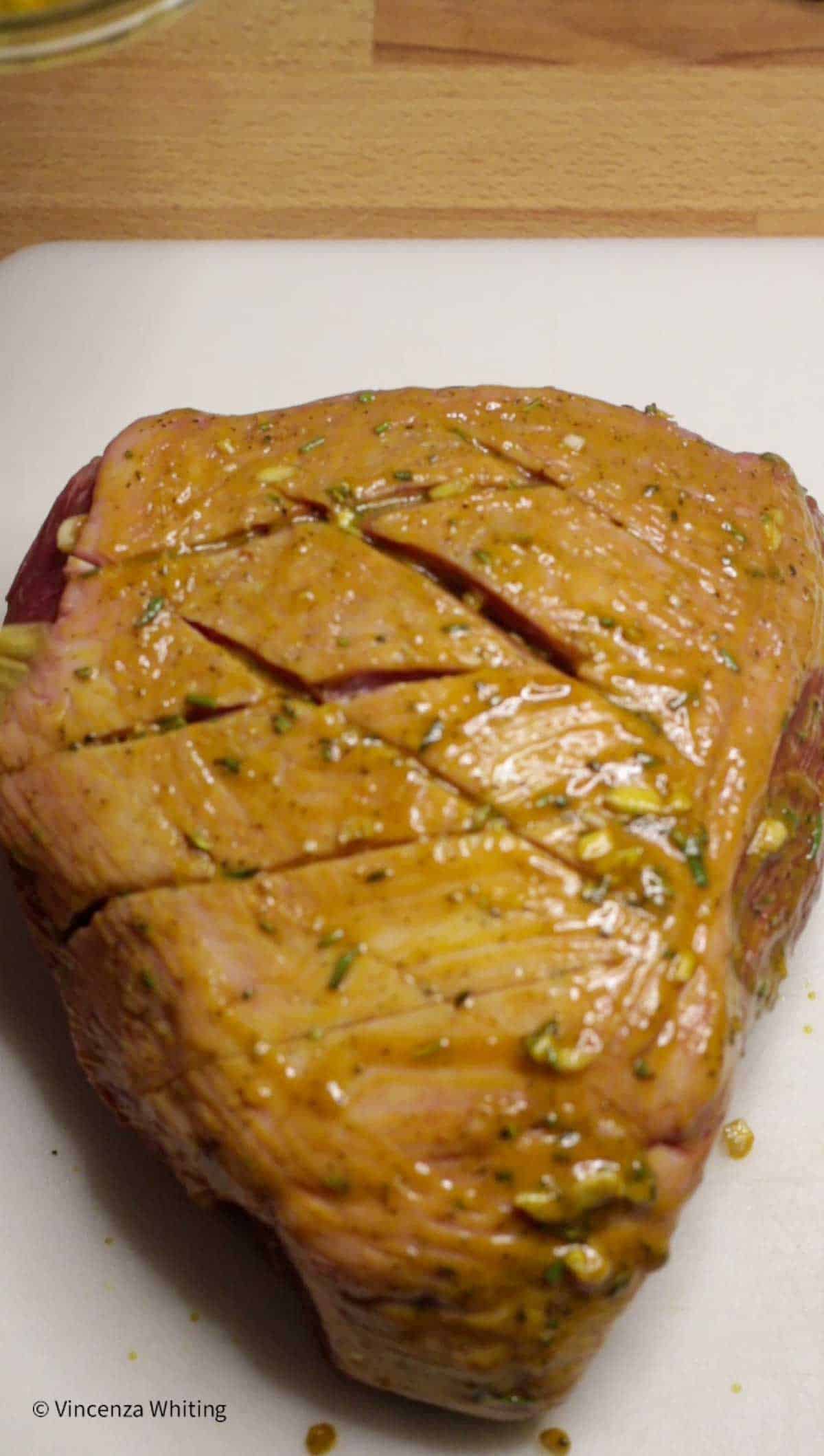 Bottom round roast beef covered in a mustard wet rub.