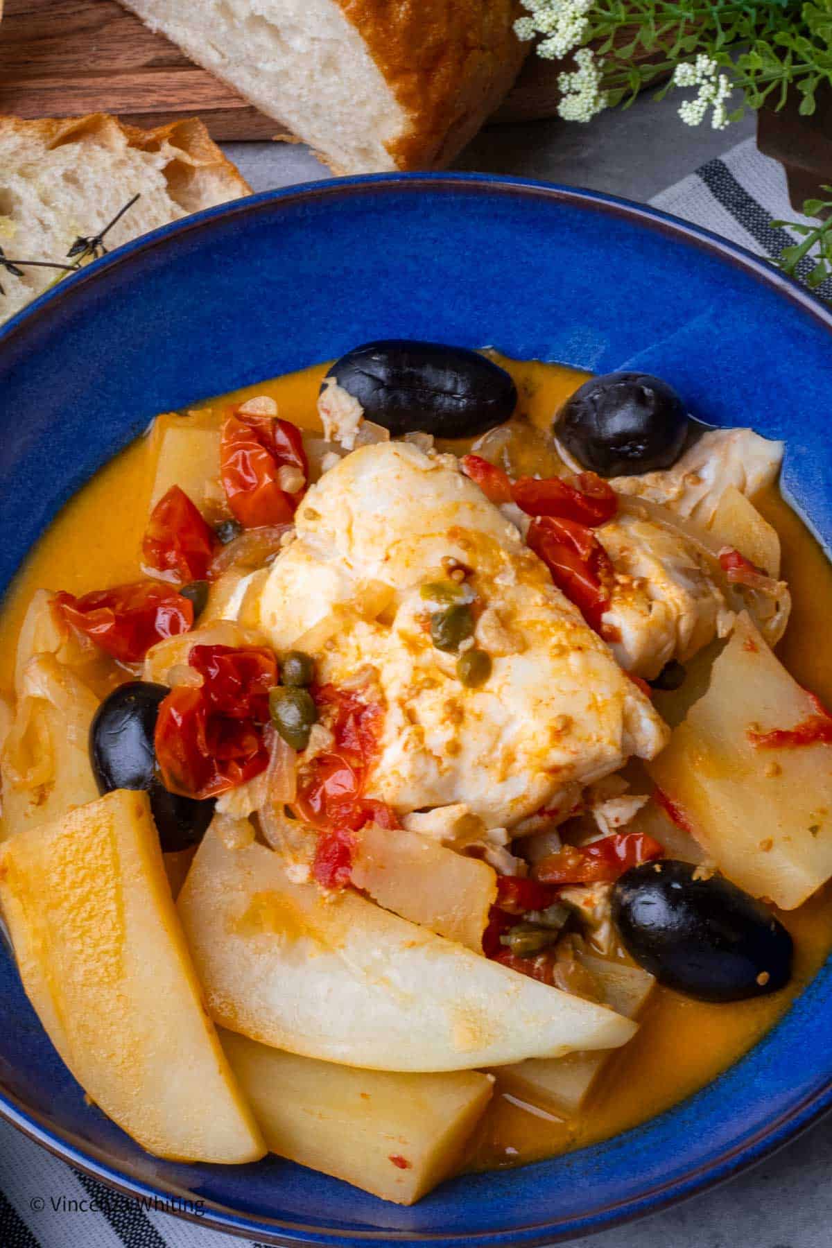 A blue bowl of pesce alla ghiotta.