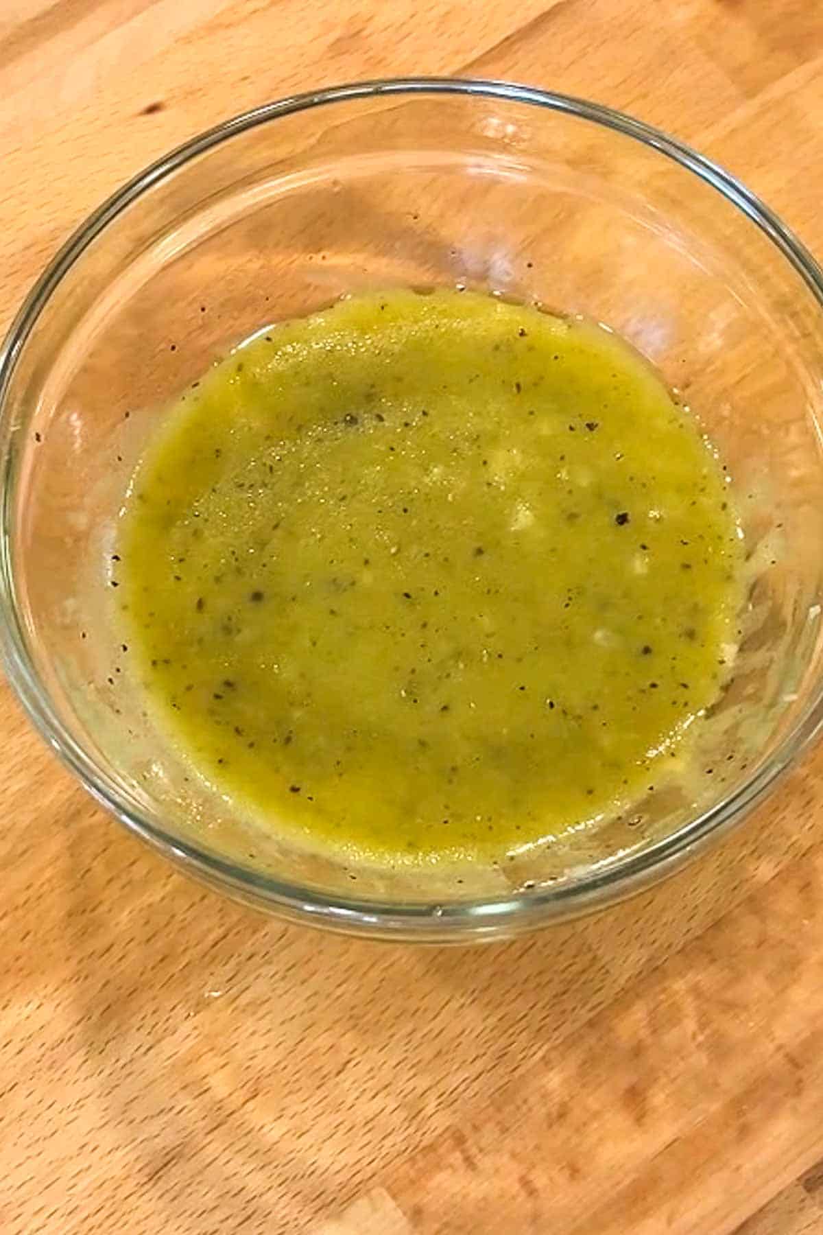 A mustard vinaigrette in a clear bowl.