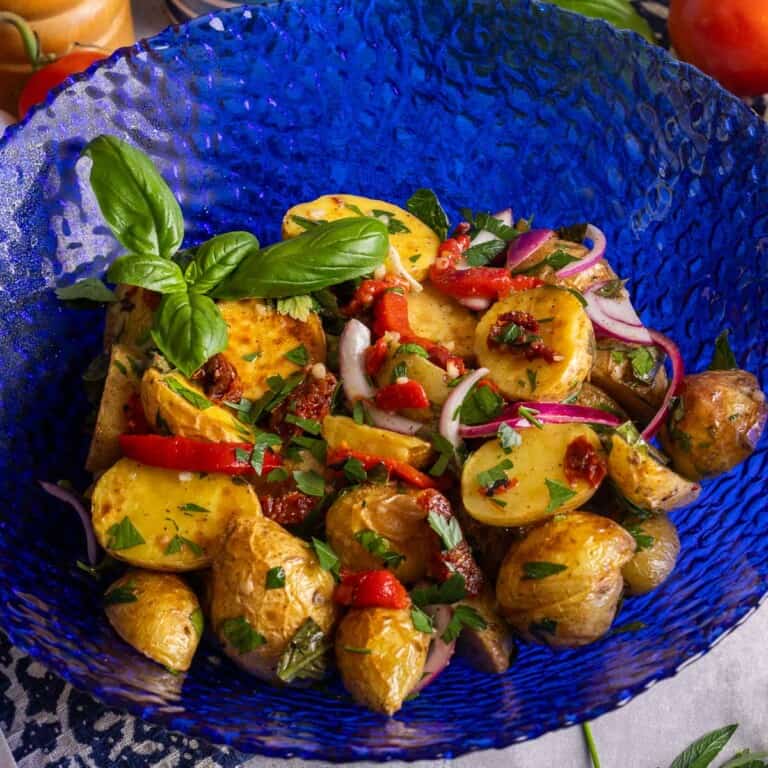 Italain Roasted Potato salad in a blue bowl.