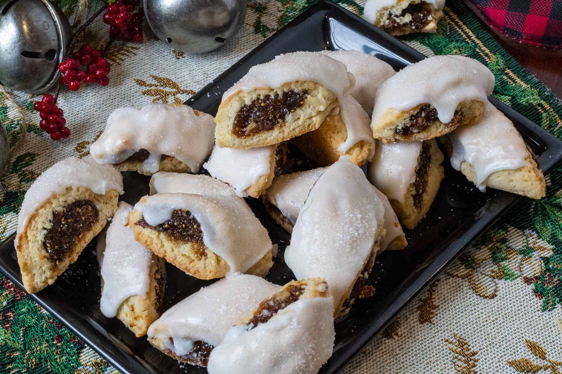 A plate of Sicilian Cuccidat cookies on a christmas background.