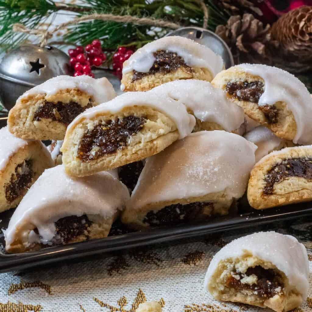 A plate of cuccidate in front of christmas decorations.