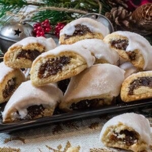 A plate of cuccidate in front of christmas decorations.