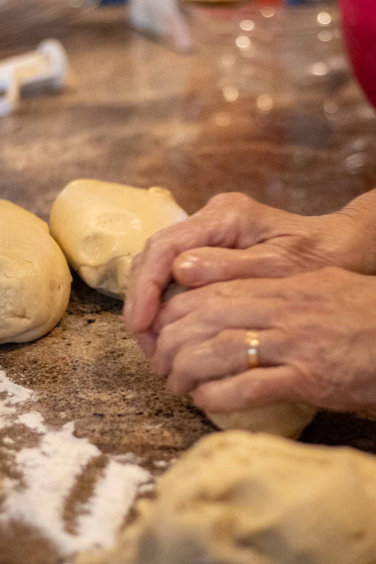 Twoo hands kneading dough.