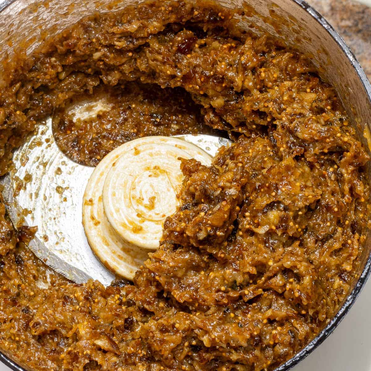 The filling for cuccidati:  A paste of ground fruits in a food processor bowl.
