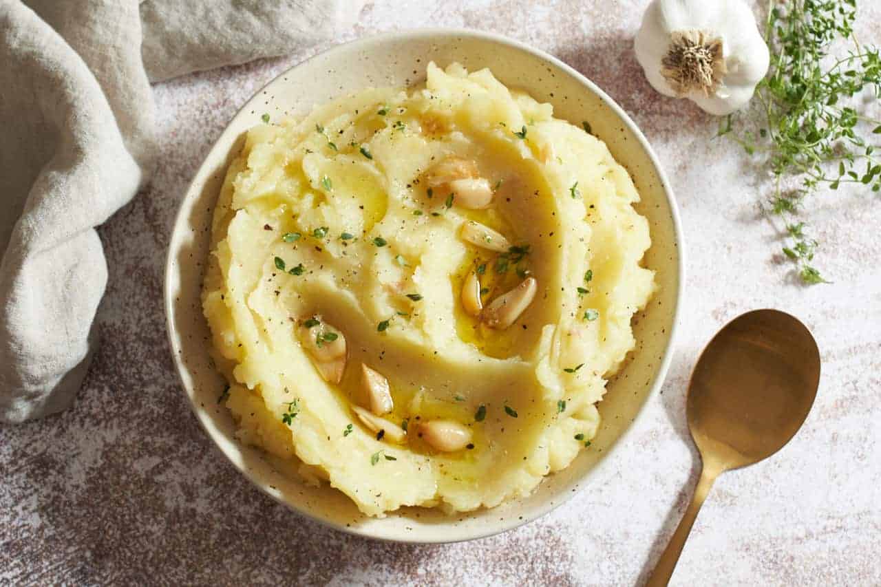Mashed potatoes topped with roasted garlic.