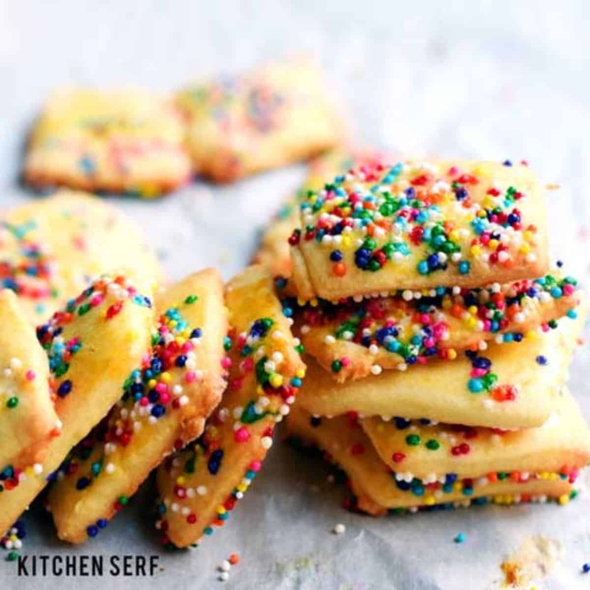 Square cookies with sprinkles on them.