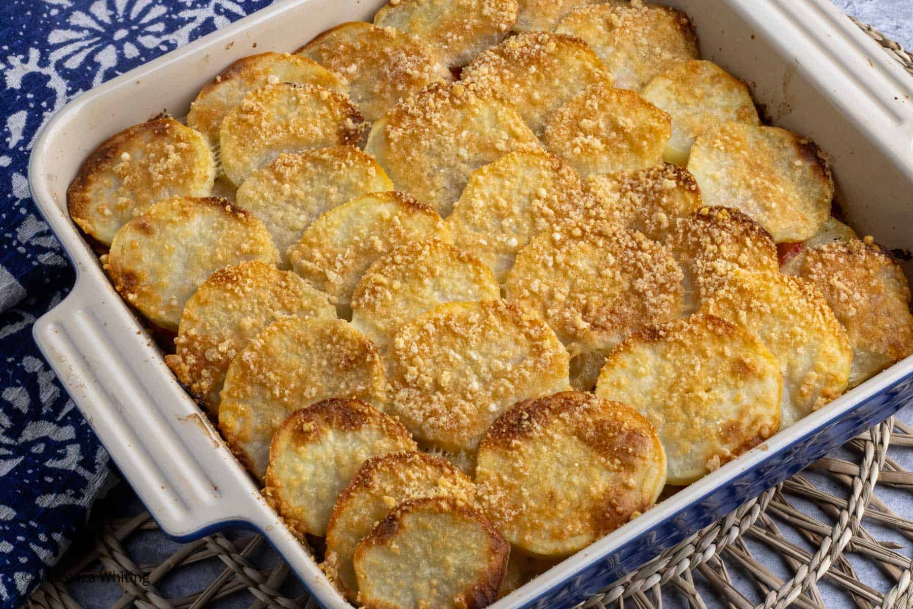 Roasted potato slices topped with Parmesan.