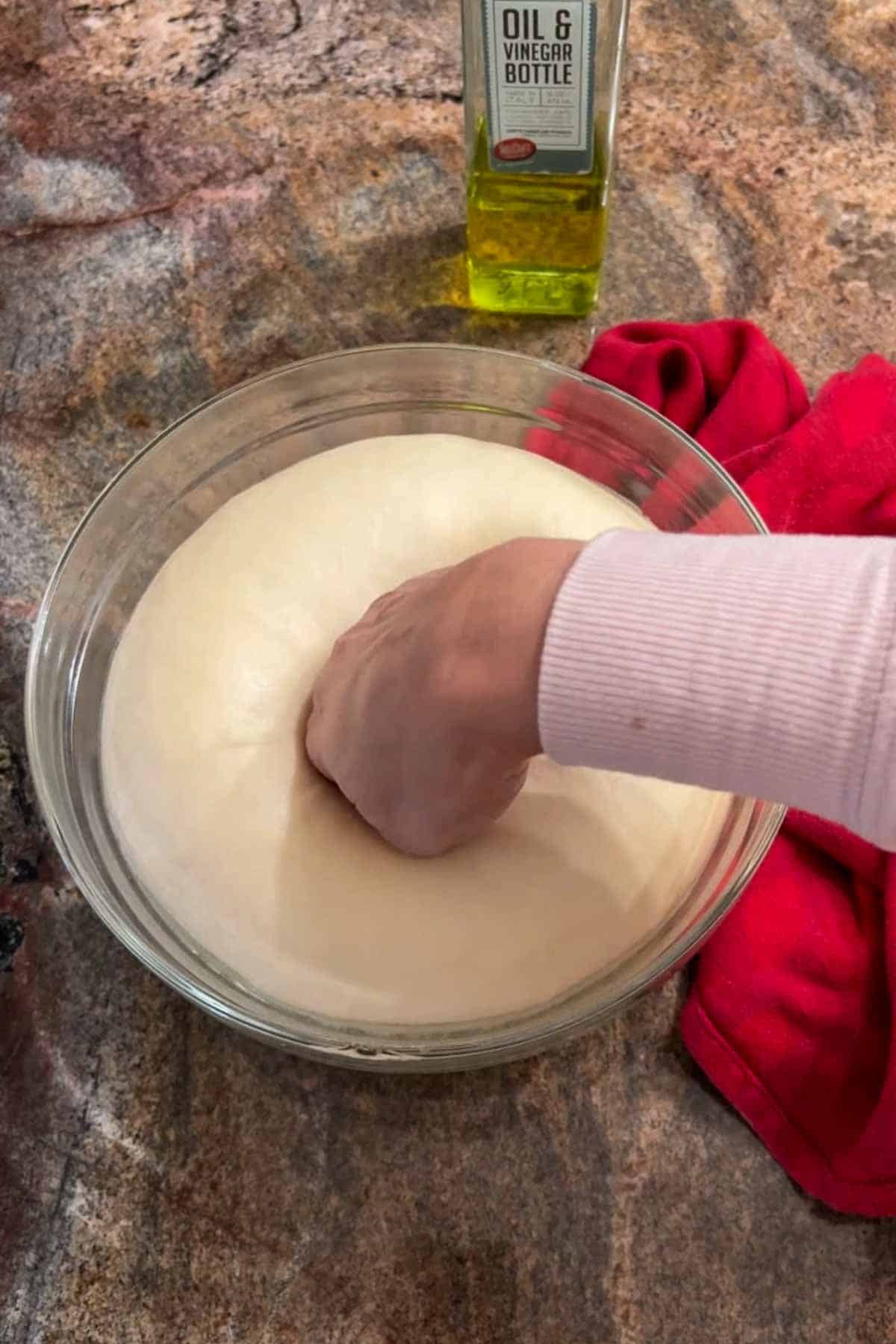 Punching down dough for pizza fritta.