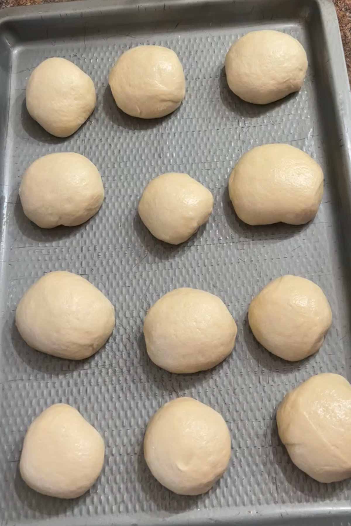 Pizza fritta dough balls on a baking sheet.